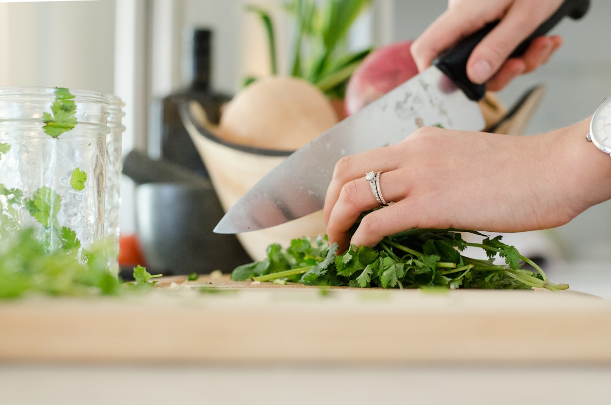 Hands preparing fresh vegetables and whole foods